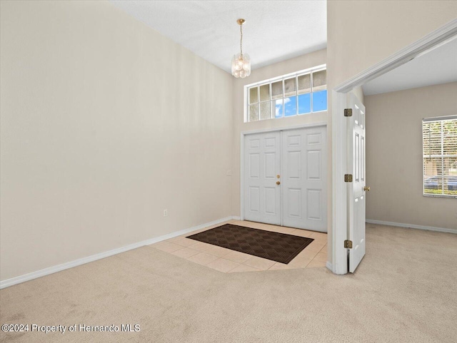 4264 Braemere Dr, Brooksville, FL 34609 - carpeted foyer entrance featuring a towering ceiling and an inviting chandelier