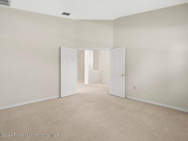 4264 Braemere Dr, Brooksville, FL 34609 - carpeted empty room featuring a towering ceiling