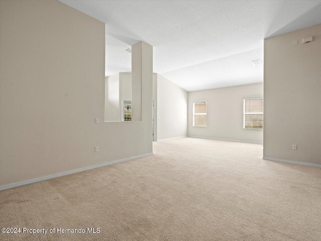 4264 Braemere Dr, Brooksville, FL 34609 - spare room featuring a textured ceiling and light colored carpet