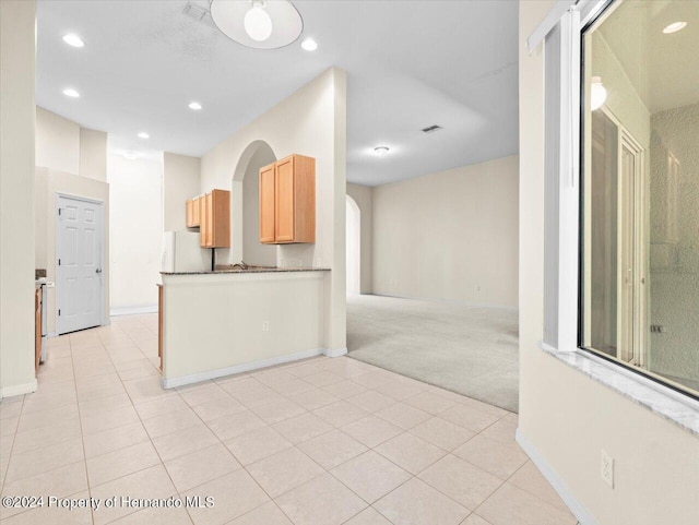 4264 Braemere Dr, Brooksville, FL 34609 - kitchen featuring light brown cabinets, light colored carpet, and white fridge