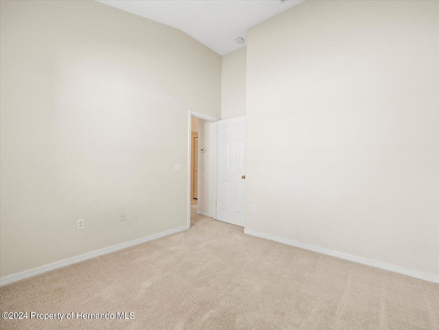 4264 Braemere Dr, Brooksville, FL 34609 - unfurnished room with light carpet and vaulted ceiling