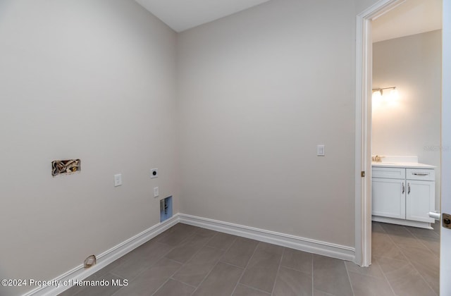 laundry area with tile patterned flooring, sink, and electric dryer hookup