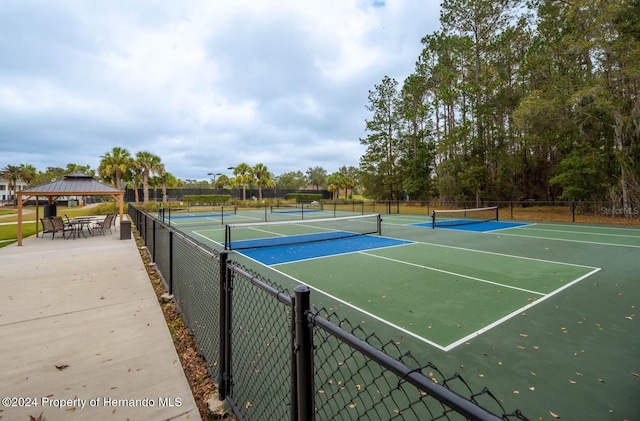 view of tennis court featuring a gazebo