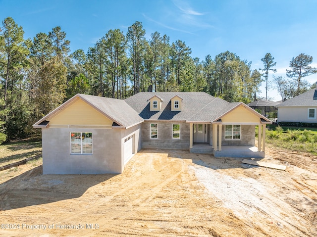 view of front of property featuring a garage and a porch