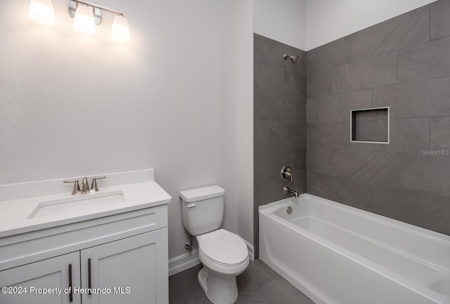 full bathroom with vanity, tile patterned floors, toilet, and tiled shower / bath