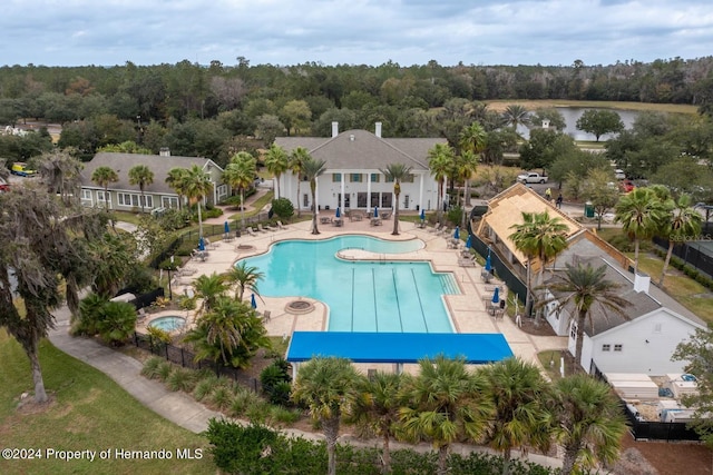 view of pool with a water view and a patio area