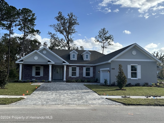 view of front facade with a garage and a front lawn