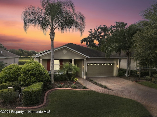 view of front of house featuring a lawn and a garage