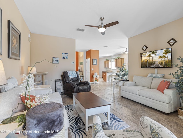 tiled living room featuring ceiling fan