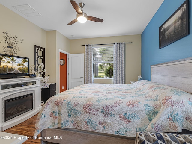 bedroom with wood-type flooring and ceiling fan