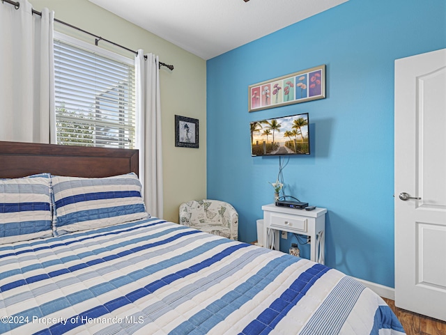 bedroom with hardwood / wood-style floors