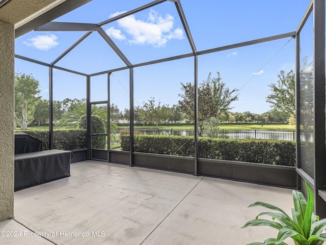 unfurnished sunroom with a water view