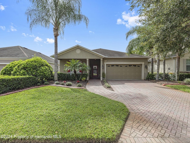 ranch-style house with a front lawn and a garage