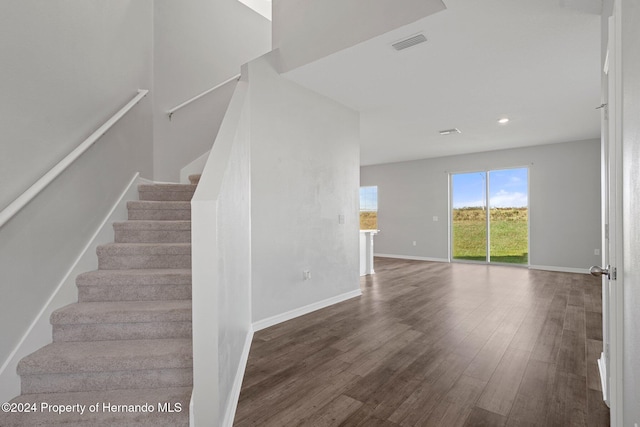 stairway featuring wood-type flooring