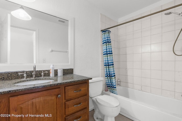 full bathroom with shower / bath combo, vanity, and toilet