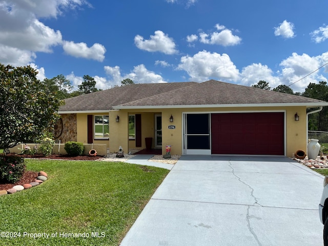 ranch-style house with a garage and a front yard