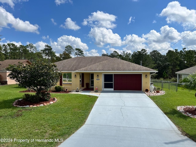 ranch-style home with a garage and a front lawn