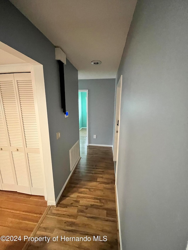 hallway with dark hardwood / wood-style floors