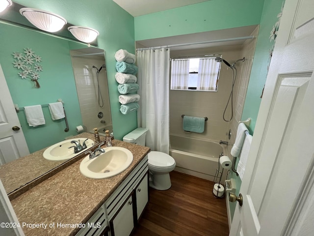 full bathroom with toilet, vanity, wood-type flooring, and shower / bathtub combination with curtain