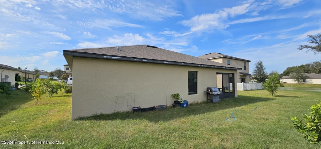 view of property exterior featuring a lawn