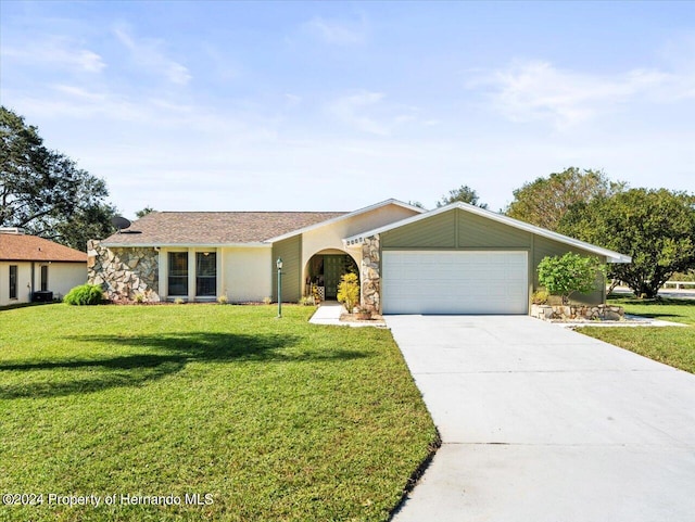 ranch-style home with a garage and a front yard