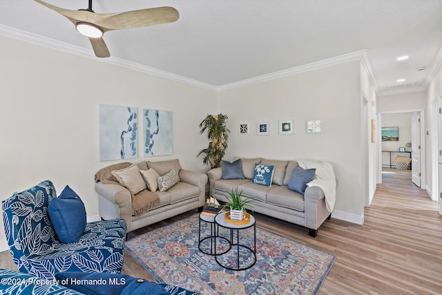 living room with hardwood / wood-style floors, ceiling fan, and crown molding