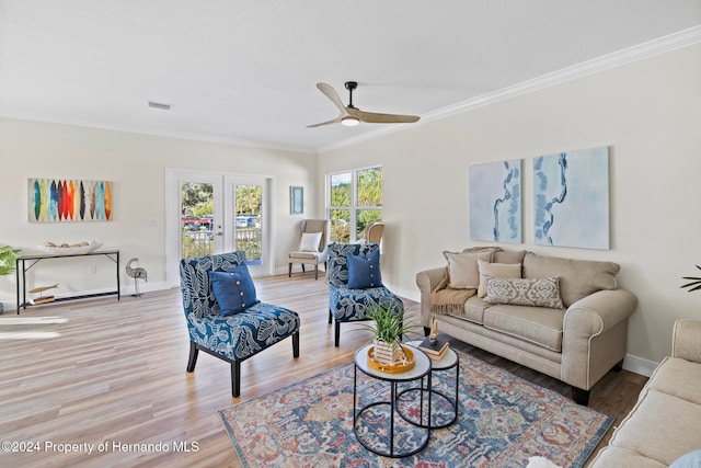 living room featuring ceiling fan, hardwood / wood-style floors, and ornamental molding