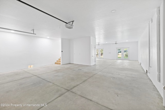 garage with a garage door opener and ceiling fan