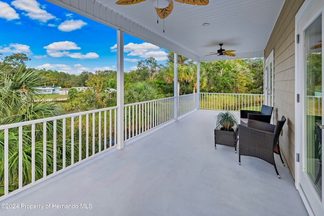 view of patio / terrace with a balcony and ceiling fan