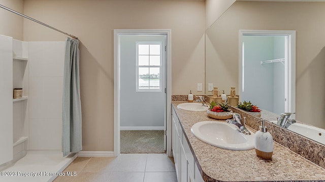 bathroom with vanity, tile patterned flooring, and curtained shower