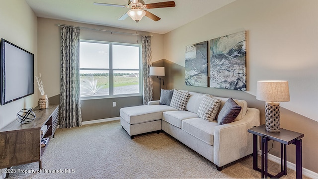 carpeted living room with ceiling fan