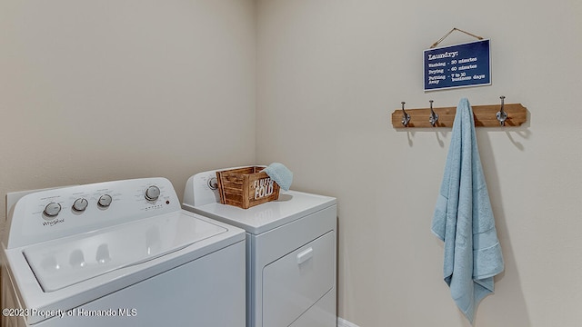 washroom featuring washing machine and clothes dryer