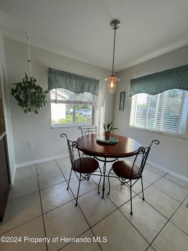 dining room with a healthy amount of sunlight and light tile patterned floors