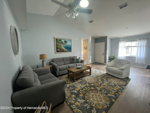 living room featuring lofted ceiling, hardwood / wood-style flooring, and ceiling fan