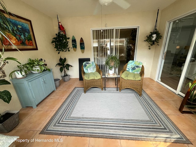 interior space with ceiling fan and light tile patterned flooring