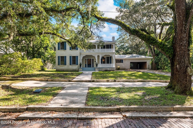 view of front of home featuring a porch and a front lawn