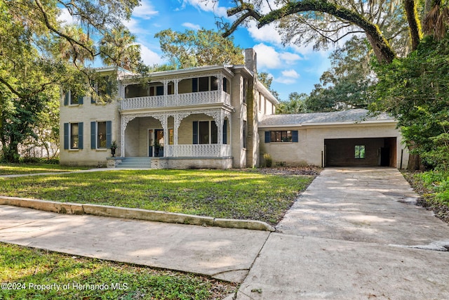 view of front of home featuring covered porch, a front yard, and a carport