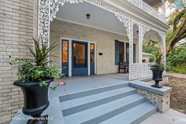 view of exterior entry with covered porch