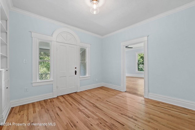 foyer entrance featuring light wood-type flooring and ornamental molding