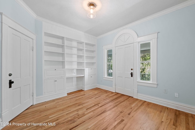 entrance foyer featuring hardwood / wood-style flooring and crown molding