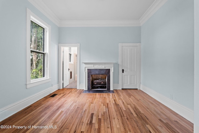 unfurnished living room featuring light wood-type flooring and crown molding