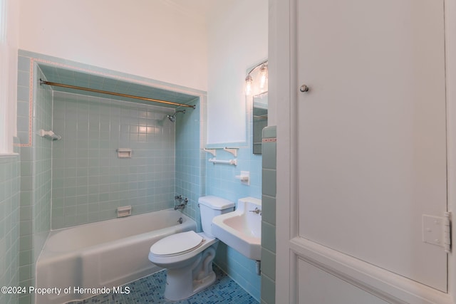 full bathroom with tile walls, tile patterned floors, sink, toilet, and tiled shower / bath