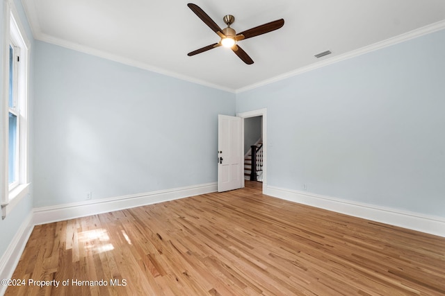 spare room with light hardwood / wood-style flooring, ceiling fan, and crown molding