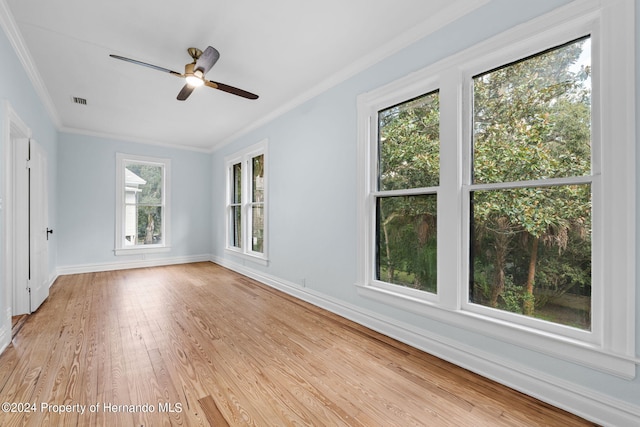 unfurnished room featuring light hardwood / wood-style floors, a healthy amount of sunlight, and crown molding