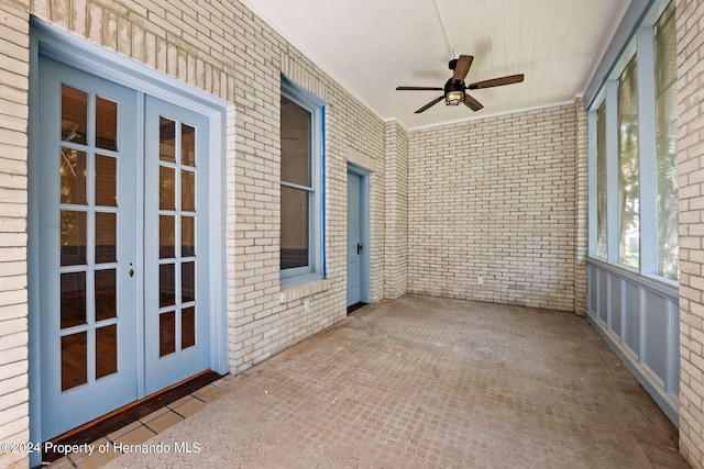 unfurnished sunroom featuring french doors and ceiling fan