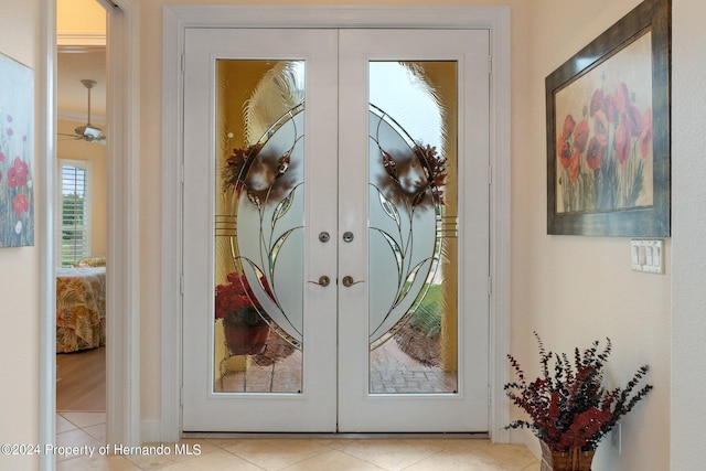 doorway with french doors and light tile patterned floors