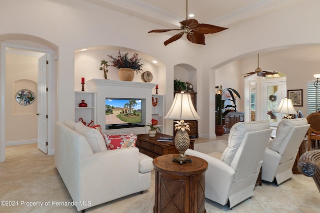 tiled living room featuring ceiling fan and crown molding