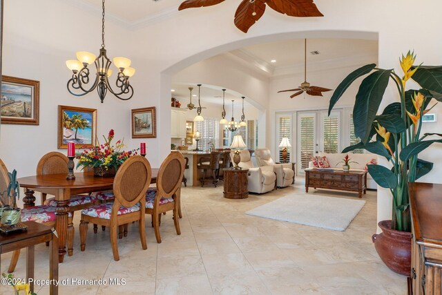 dining room featuring ornamental molding and ceiling fan with notable chandelier