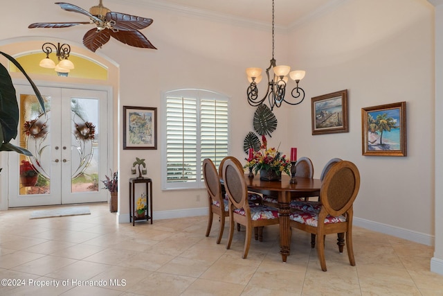 dining room with ornamental molding, french doors, ceiling fan with notable chandelier, and light tile patterned floors