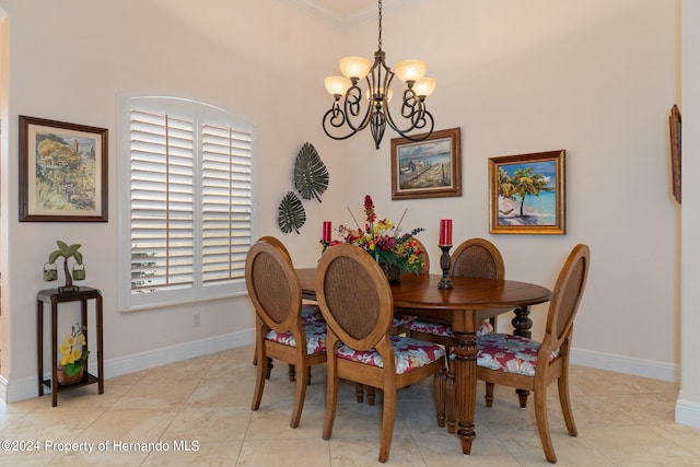 dining space featuring light tile patterned flooring, crown molding, and a notable chandelier